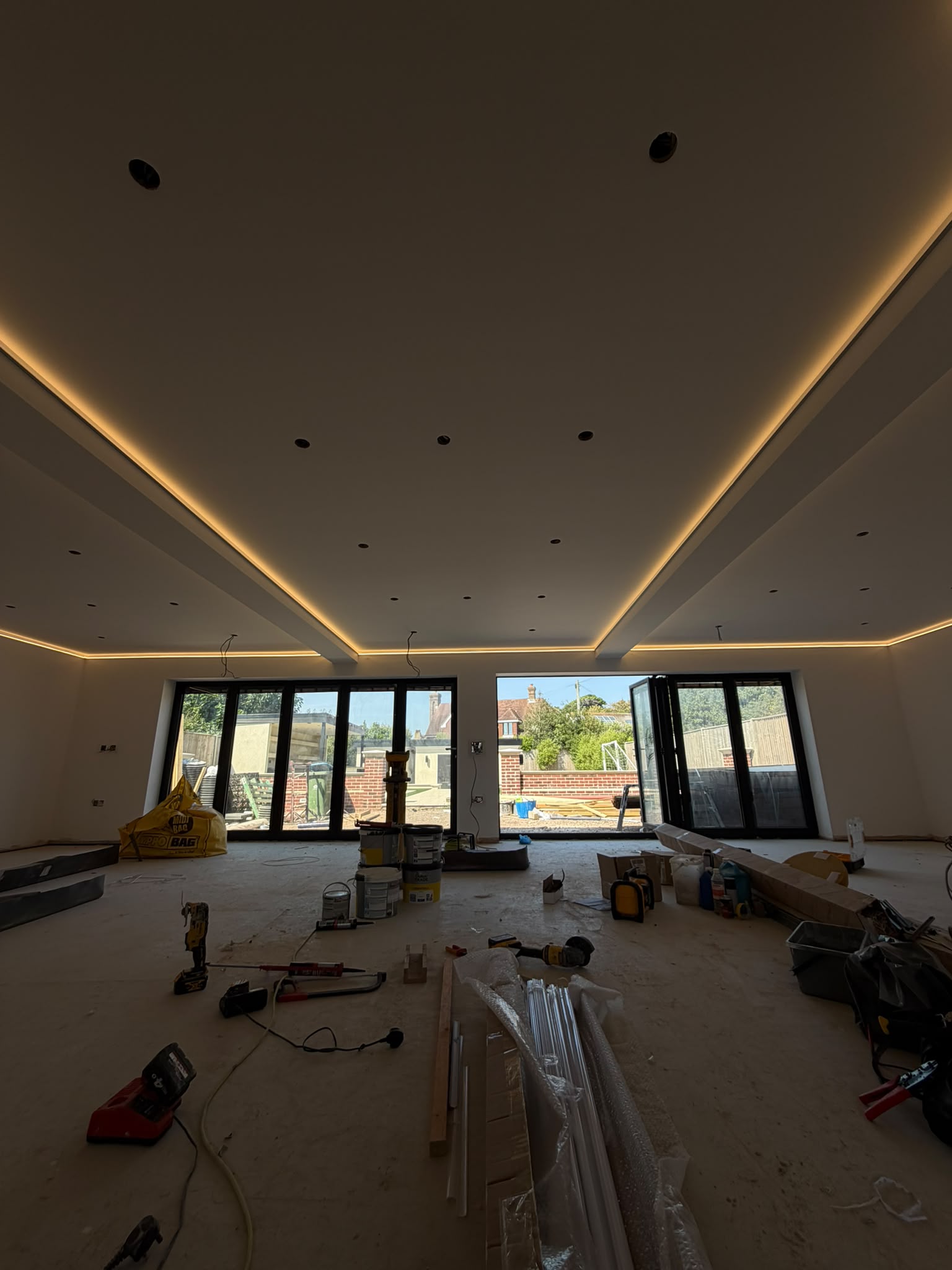 Open-plan room with continuous cove LED lighting to the perimeter