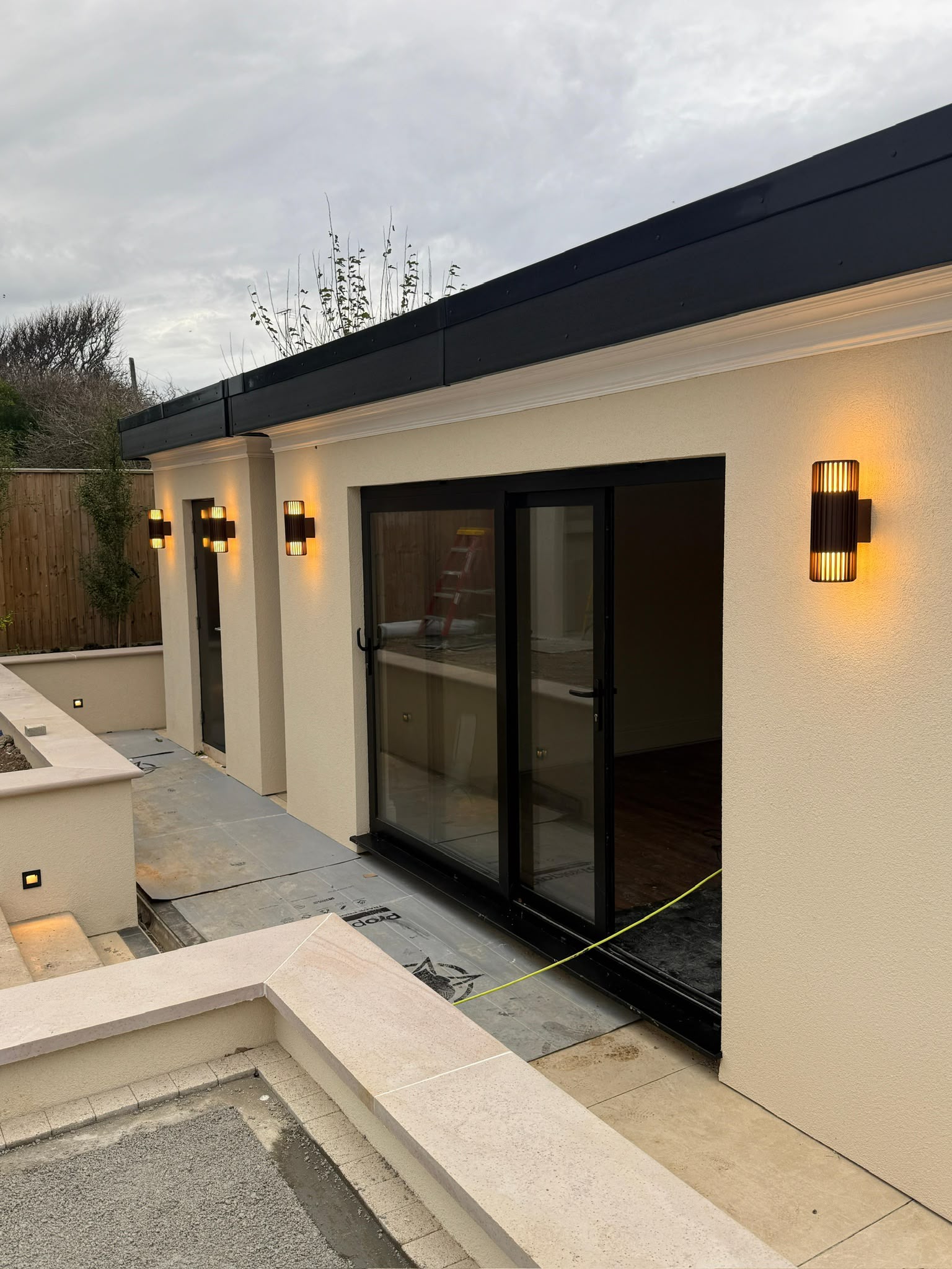 Exterior wall lights and recessed step lights on a rear terrace